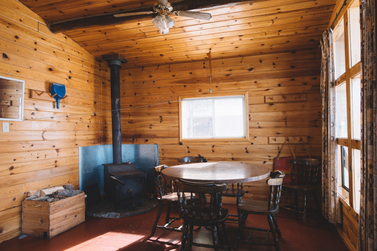 Table and fire place inside Whitewater Outpost Cabin in Northern Ontario